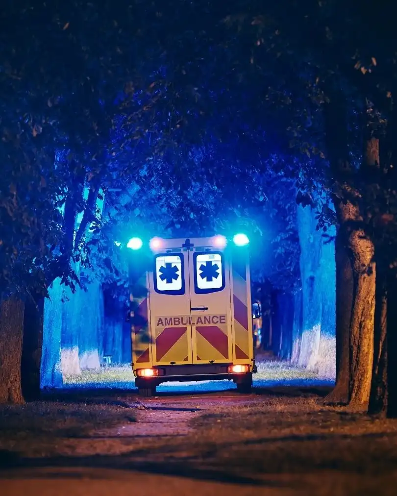 Ambulance at night with emergency lights flashing